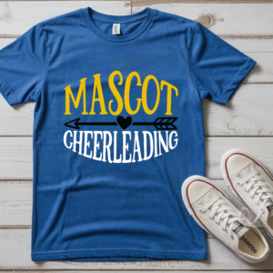 Blue t-shirt with bold yellow and white “Mascot Cheerleading” design featuring arrow and heart graphic, displayed flat with white sneakers on wooden background.