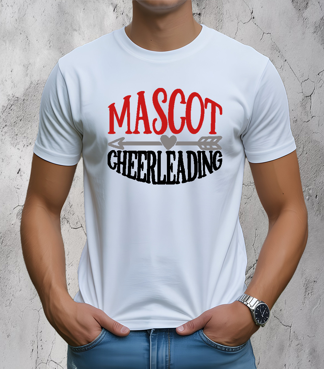 Man wearing a white t-shirt with bold red and black “Mascot Cheerleading” design featuring a heart and arrow graphic, located in the front center of the shirt. Man is standing against a textured light gray wall.