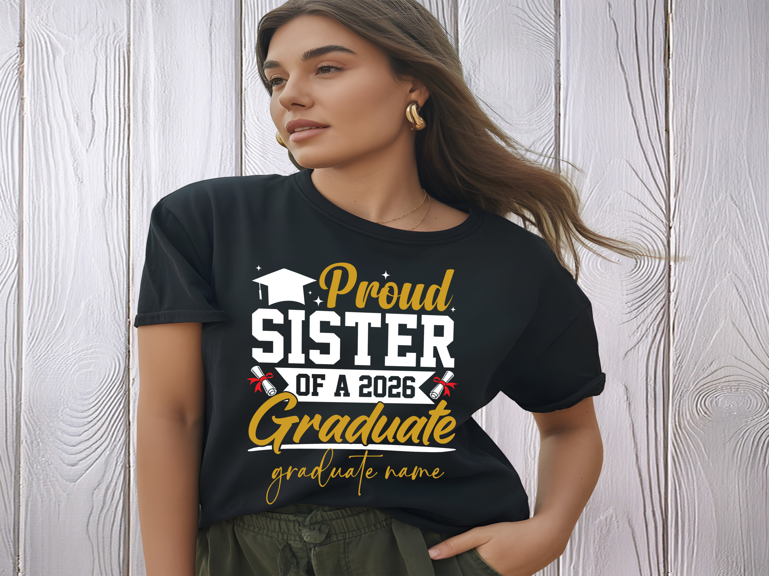 Woman wearing a black “Proud Sister of a 2026 Graduate” personalized t-shirt with graduation cap and diploma graphics and custom graduate name — matching family graduation apparel for class of 2026 celebration.