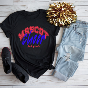 Black custom cheerleading t-shirt with red, blue, and white “Mascot Cheer Name” design, styled with jeans, black sneakers, and a gold pom-pom on a white wood background.