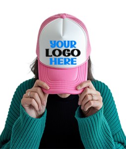 Person wearing a pink and white trucker hat with a customizable front panel displaying the text “Your Logo Here