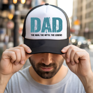 White and black trucker hat with teal DAD graphic reading The Man The Myth The Legend – funny dad hat gift for father