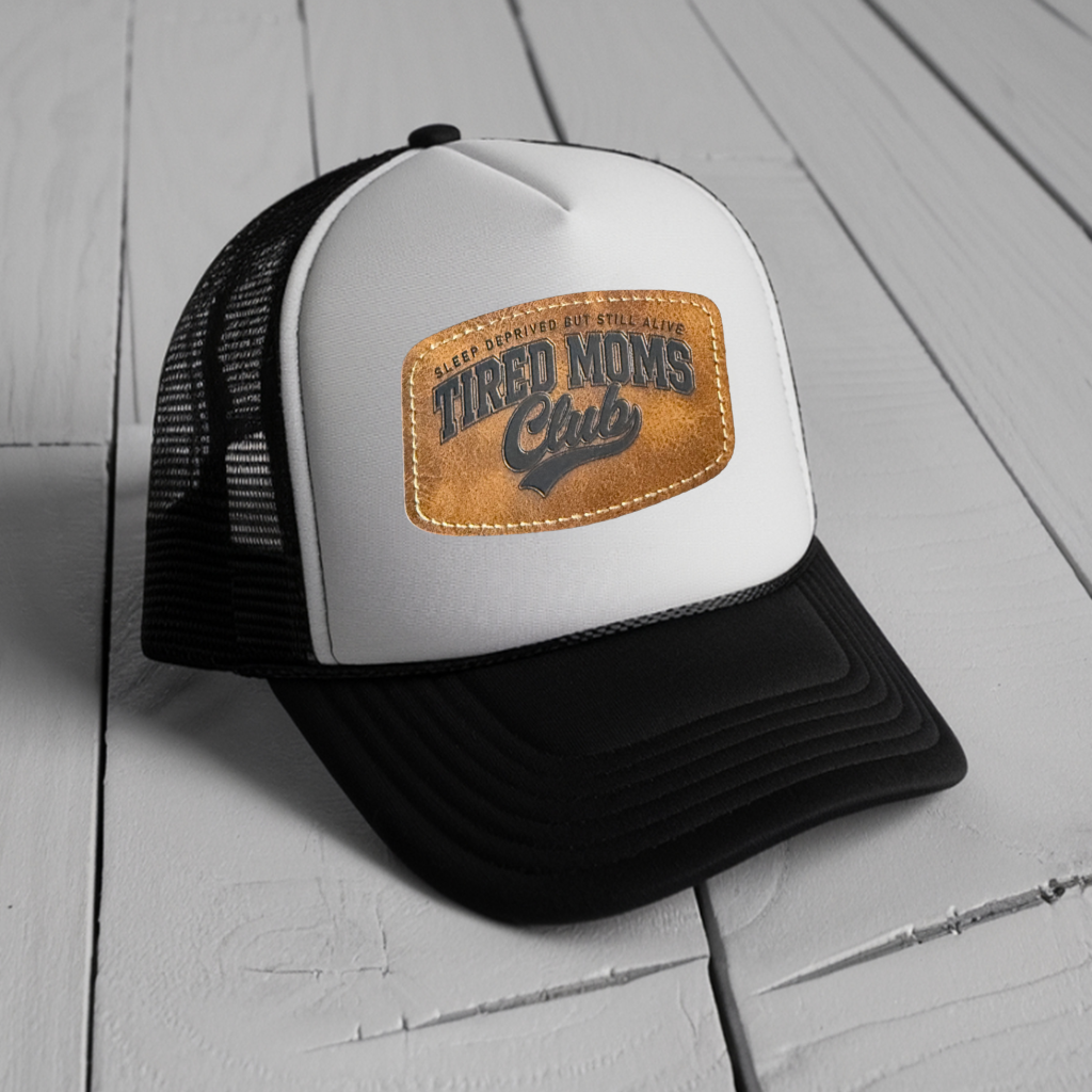 White and black mesh snapback trucker hat with cognac stadium leather patch laser engraved with Tired Moms Club Sleep Deprived But Still Alive design