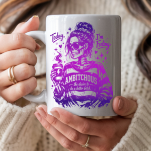 White ceramic coffee mug featuring a purple gradient skull woman in sunglasses holding a coffee cup, with the text "Today I'm Feeling Ambitchous – the desire to be a better bitch"