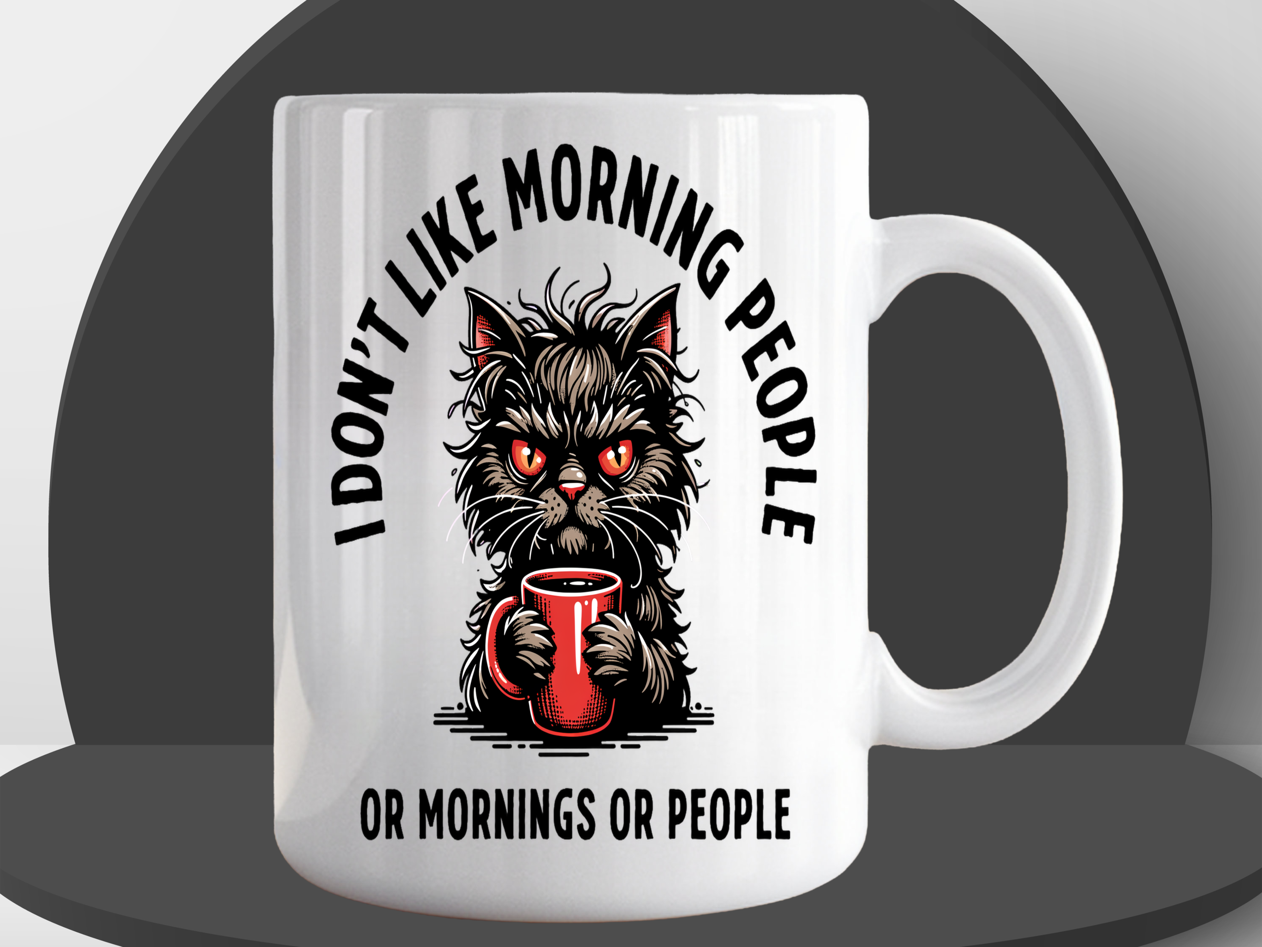 White ceramic coffee mug featuring an angry fluffy cat with glowing red eyes clutching a red coffee mug, with the text "I Don't Like Morning People Or Mornings Or People"