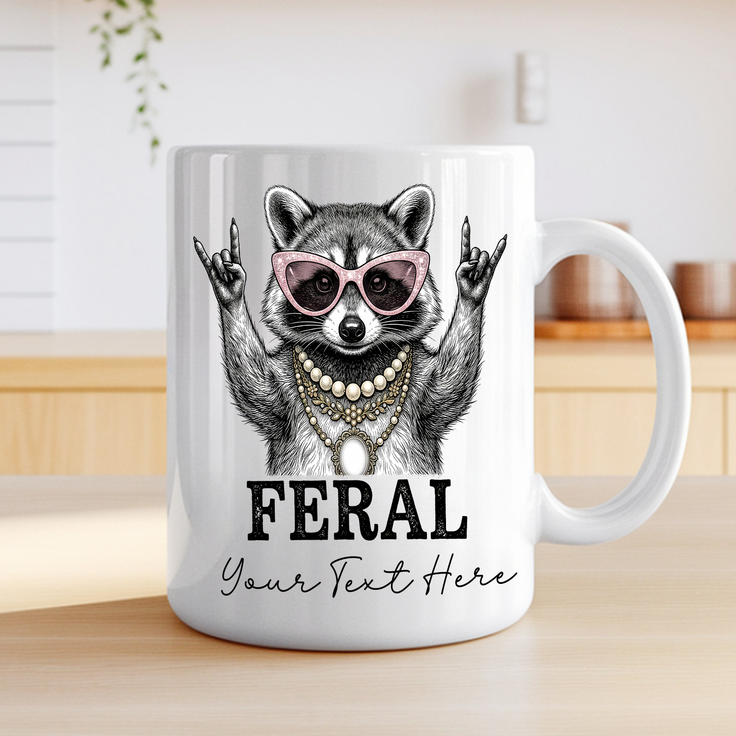 White ceramic coffee mug featuring a illustrated raccoon wearing pink cat-eye sunglasses and layered pearl and gold necklaces, throwing rock-on hand signs, with the word "FERAL" in bold text with personalization text— on a table