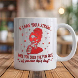 White coffee mug featuring a red gradient skull woman with sunglasses holding a coffee cup, surrounded by stars, with the text "If I give you a straw... will you suck the fun out of someone else's day?" displayed on a wooden table